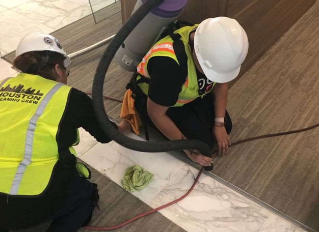 Houston Cleaning Crew performing detailed floor cleaning on a commercial construction project